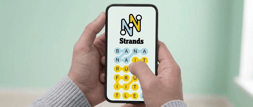 NYT Strands puzzle on a phone — theme words highlighted in blue and the spangram in yellow